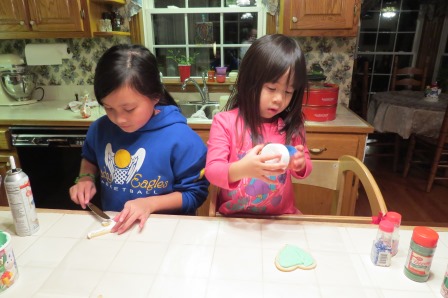 Kasen and Karis making Santa cookies